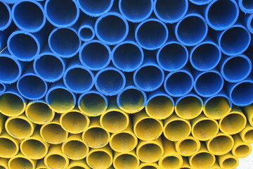 Round, metal blue and yellow pipes in section, background, wallpaper, texture, color 