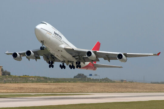 Luqa, Malta April 16, 2005: Qantas Boeing 747-438 takes off from Malta International Airport. Qantas used to operate direct flights from Malta to Australia in the late 80's and early 90's.