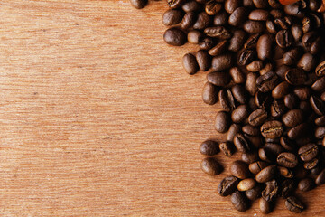 Coffee beans in the upper right corner on a wooden table.