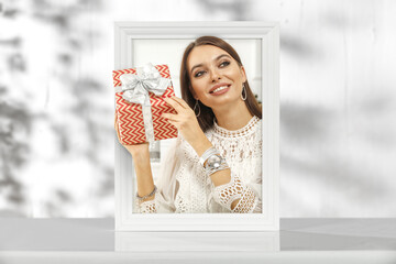 Picutre frame on white desk and slim young woman 