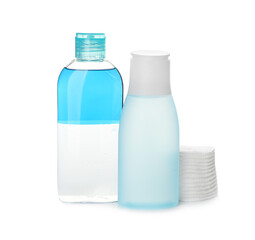 Cosmetic products and cotton pads for makeup removal on white background