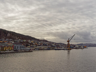 Fototapeta na wymiar Apartments, Houses and Maritime Buildings all mixed up with one another on the waterfront of Bergen Port under a winters sky.