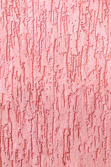 Textured surface coat plaster walls red color. Vertical photo.