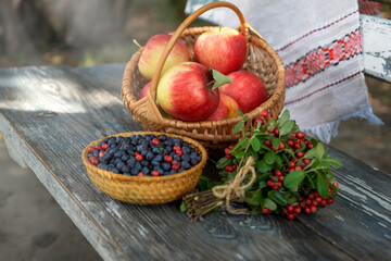 Still life with berries, apples and honey, a holiday at the end of summer, harvesting.