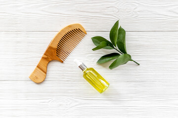 Essential oil for hair care with wooden hair comb - obrazy, fototapety, plakaty