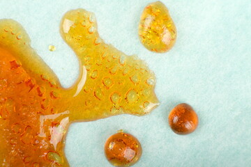 cured orange-yellow cannabis wax, marijuana resin dab closeup. - obrazy, fototapety, plakaty