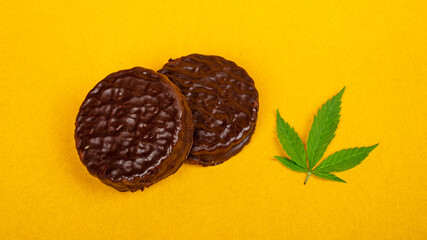 chocolate cannabis cookies with high thc on yellow background, recreational cannabis use.