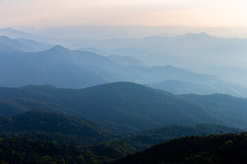 Natural scene of hazy blue mountain range of tropical rainforest.