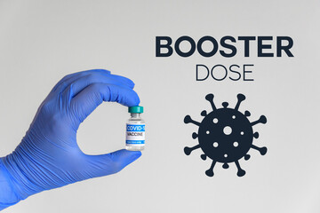 Medical worker holding vaccine in front of white background and booster dose text