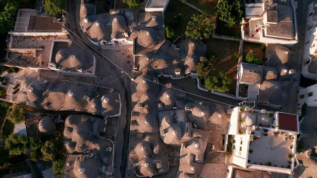 aerial view of trulli of alberobello town in Italy. drone fly over old town buildings at sunrise