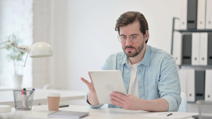 Young Man using Tablet at Work