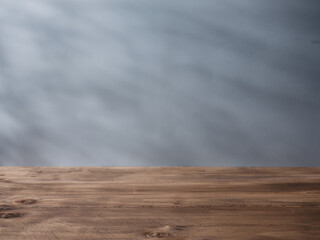 Wooden table for product presentation and gray wall on background