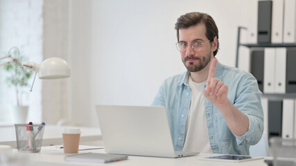 No Gesture with Finger by Young Man at Work