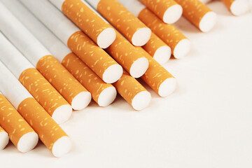 image of several commercially made pile cigarette on white  background. or Non smoking campaign concept, tobacco pattern top view.