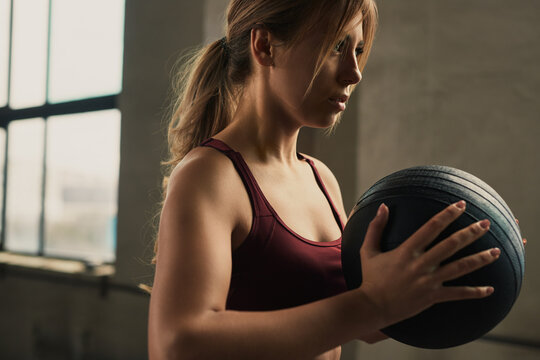 Young Woman Exercising With Medicine Ball