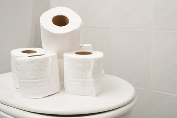The tissue paper was placed on the toilet bowl in the bathroom.