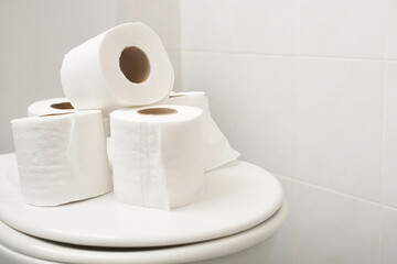 The tissue paper was placed on the toilet bowl in the bathroom.