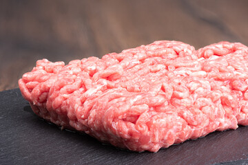 Close-up of ground beef on a black slate stone board.