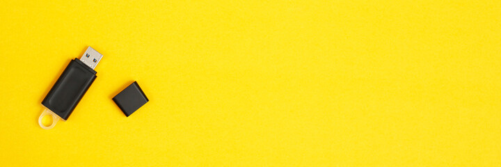 Flash drive for data storage placed on a yellow background