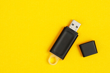 Flash drive for data storage placed on a yellow background