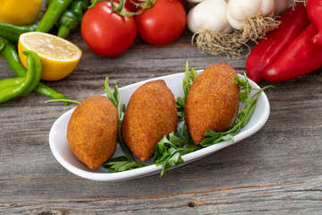 Kibbeh on a wooden background. Stuffed Meatballs Food, Falafel, icli Kofta, Quibe