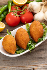 Kibbeh on a wooden background. Stuffed Meatballs Food, Falafel, icli Kofta, Quibe
