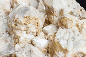 Macro mineral stone Snow quartz with calcite on a black background