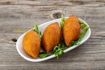 Kibbeh on a wooden background. Stuffed Meatballs Food, Falafel, icli Kofta, Quibe