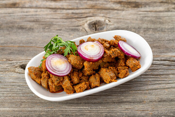 Cooked liver on wood floor. Traditional Turkish appetizer.