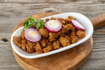 Cooked liver on wood floor. Traditional Turkish appetizer.