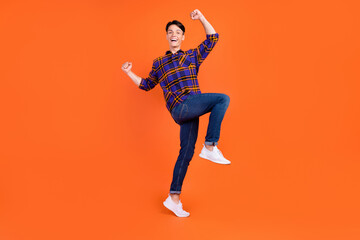 Plakat Full size photo of young cute guy yell wear shirt jeans sneakers isolated on orange background