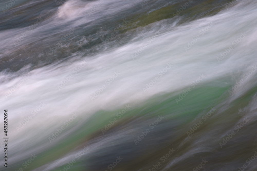 Poster abstract background from long exposure of water stream in a mountain river close-up