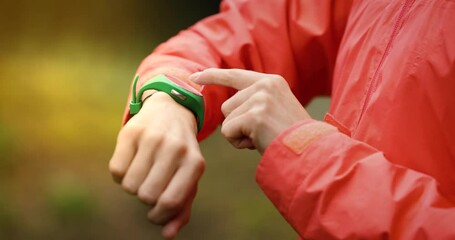 sport technology - woman using fitness tracker or smartwatch to track health and exercise on outdoor workout