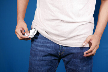 young man shows empty pant pocket with copy space 