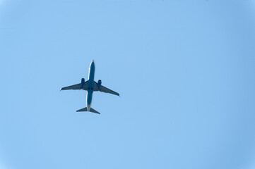 A beautiful plane is flying in the blue sky