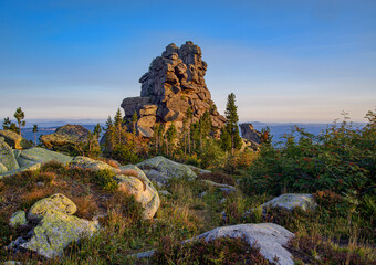 picturesque view of ruined old building among stones on top of mountain 