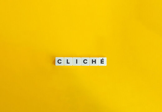 Cliché word on block letter tiles. Minimal aesthetics.