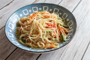 Papaya salad on the wooden table, Thai food.