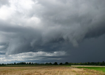 Fototapeta premium landscape with storm clouds, contrasting colors in nature before rain, autumn approaching time