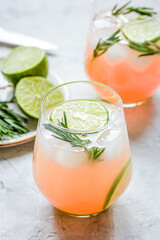 healthy morning with fresh drink, lime and rosemary on stone table background