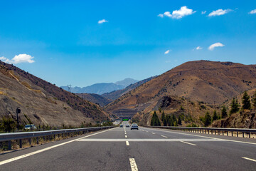 road landscape, perspective vanishing among the mountains on the horizon.