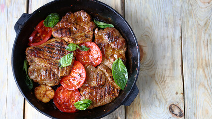 Grilled juicy steaks in a pan. Delicious meat.