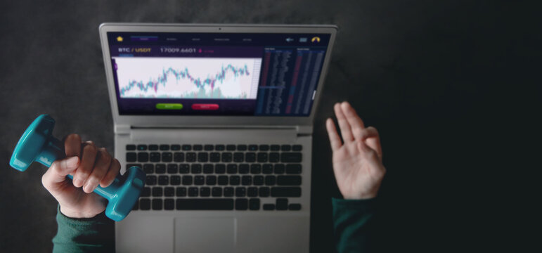 Cryptocurrency Investment Concept. Woman making Meditation Yoga and Exercising with Dumbbell  while Using Computer Laptop to Trading Bitcoin. Blockchain,Fintech Technology