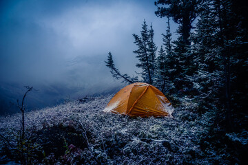 tent in the mountain forest with snow