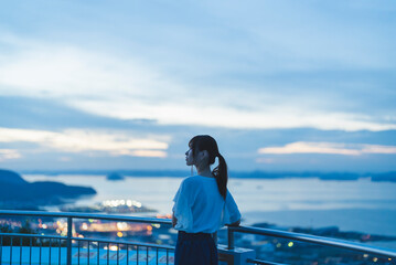 Fototapeta premium 夕暮れの展望台にいる女性