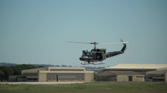 An American military helicopter flies in slow motion, near, on military exercises, over the base of the armed forces.