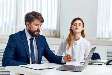 colleagues talking at the table in front of laptop professionals technology