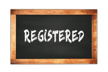 Fototapeta premium REGISTERED text written on wooden frame school blackboard.