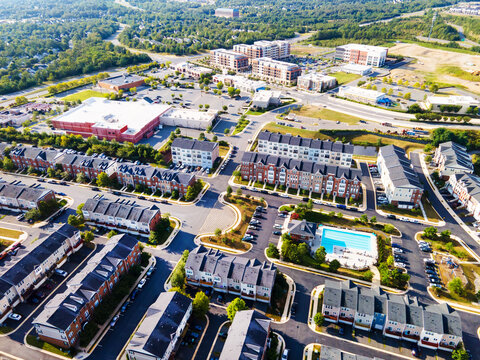 Aerial view of a residential area with a swimming pool from a drone
