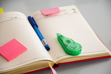 notebook with colorful stickers, concealer and pen